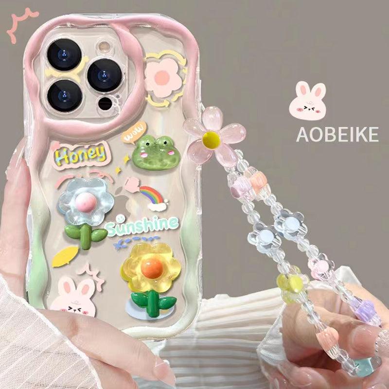 Coque transparente iPhone 15 avec décorations fleurs, animaux mignons et bracelet chaîne fleur rose et blanc. - Wiqeo
